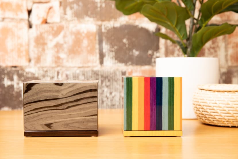 Small decorative keepsake urns in wood grain and rainbow designs